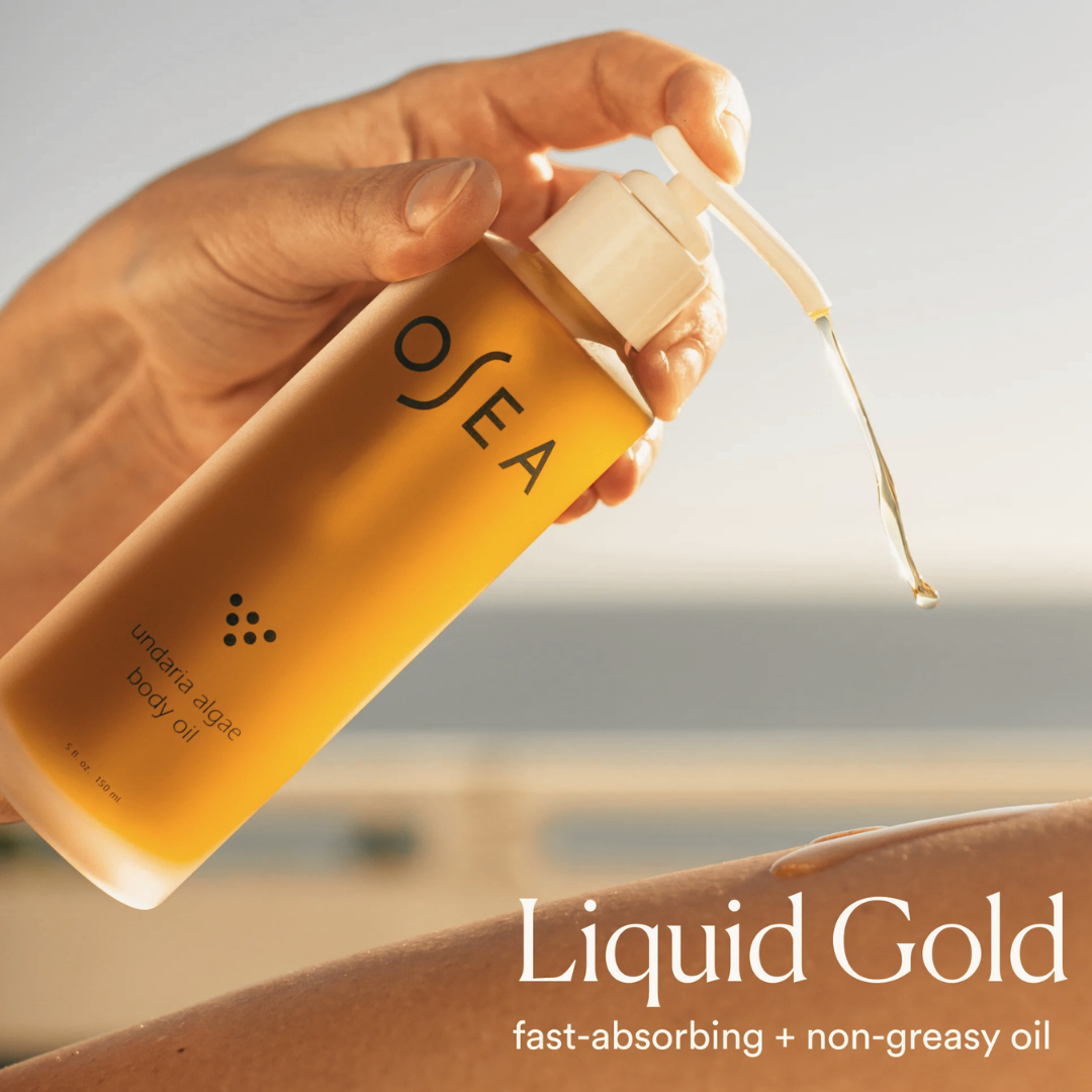 Hand applying OSEA Undaria Algae Body Oil fast-absorbing non-greasy body oil